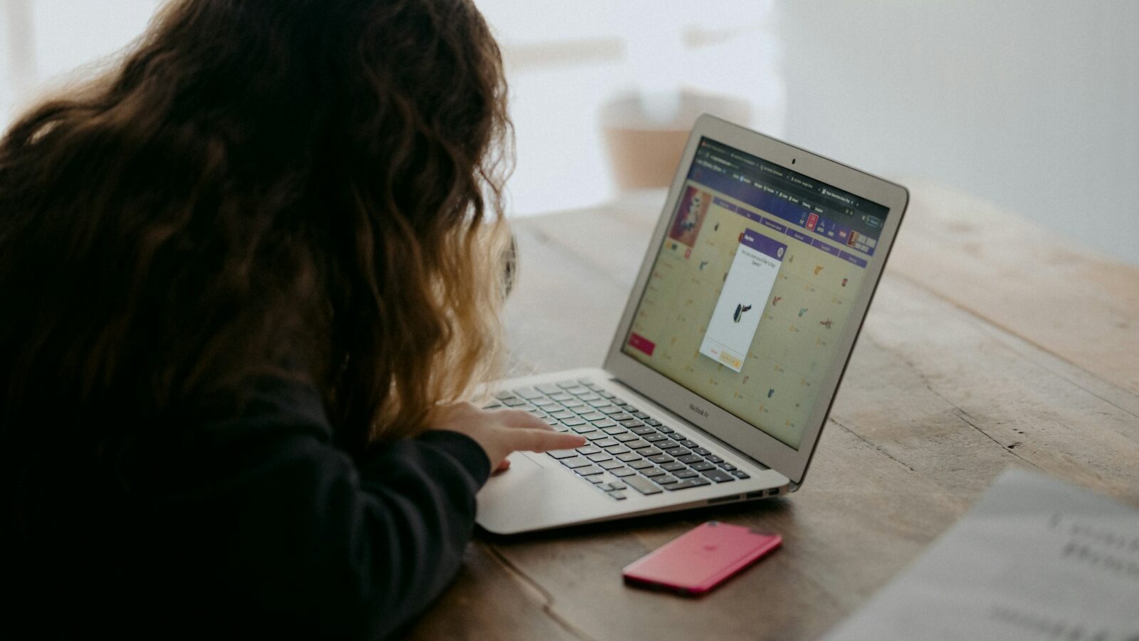 woman in black long sleeve shirt using macbook air